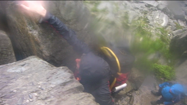 John Proctor climbs a rocky outcrop in Snowdonia is the pouring rain. © Tim Dobson 2012. CC-BY-SA 3.0